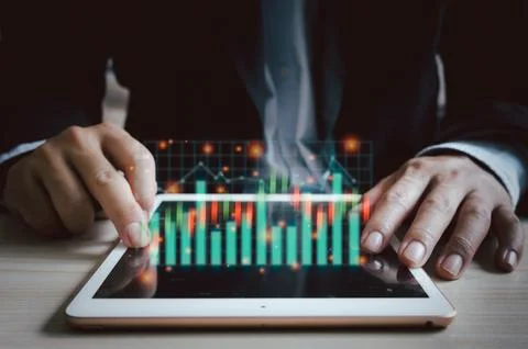 Business man tablet virtual screen stock graph and charts.Business digital .. Stock Photos