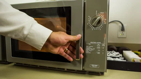 Business man taking left overs out of microwave oven at work Video stock 32243281