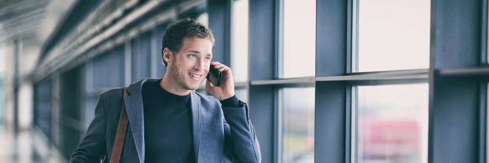 Business man talking on phone walking in airport using smartphone 5g tech device Stock Photos