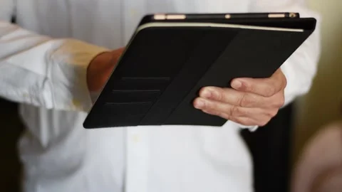 Business man tapping and scrolling a Tablet device Stock Footage 237534896