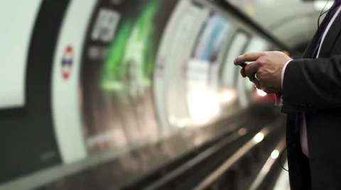 Business man texting messagge while waiting for the tube Stock Footage 65220007