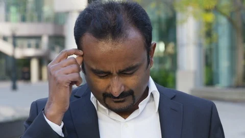 Business man thinks hard to remember a point for the camera - slow motion - shot Stock Footage 124080337