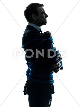 Business man tied up prisoner silhouette Stock Photos