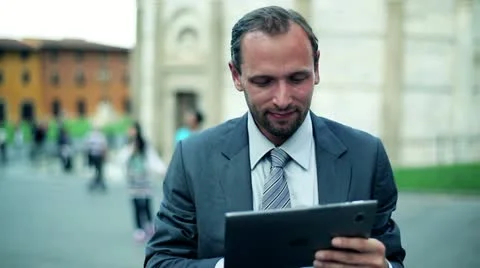 Business man in tourist city using tablet computer Stock Footage