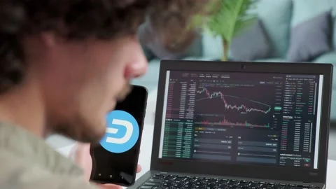 Business man trader using mobile phone app and laptop analytics. Stock Footage 168531264