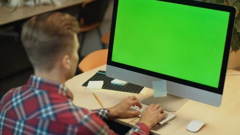 Business man typing on computer with green screen. Young man working on computer Video stock 111497067