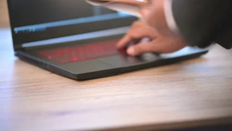 The business man is typing data on a laptop on the desk Stock Footage 137516279