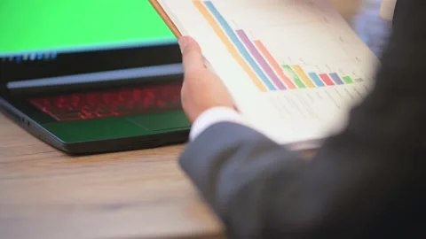 The business man is typing data on a laptop on the desk Stock Footage 137516331
