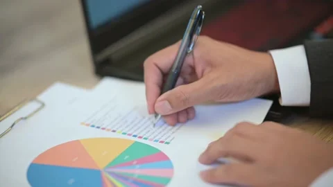 The business man is typing data on a laptop on the desk Stock Footage 137516444