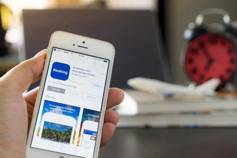 Business man is using Booking.com application on his iPhone. 库存照片