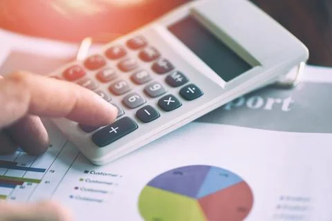 Business man using calculator for report financial statistics documents on .. Stock Photos