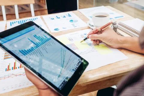Business man Using digital tablet  with Report chart outdoor Cafe Stock Photos