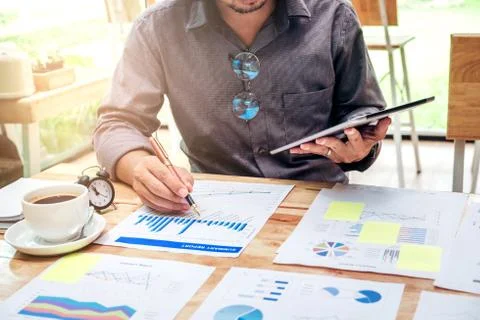 Business man Using digital tablet with Report chart outdoor Cafe Stock Photos