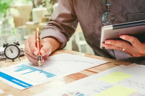 Business man Using digital tablet with Report chart outdoor Cafe Stock Photos