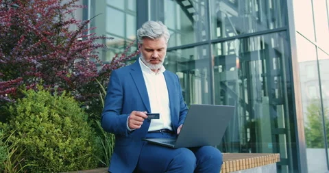 Business man using laptop and credit card for online banking while sitting near  Stock-Footage 331160115