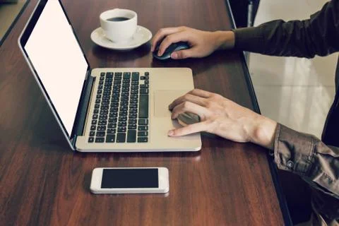 Business man using laptop computer on table in office. Stock Photos