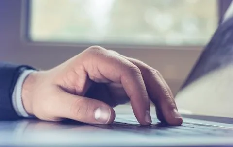 Business man using laptop computer. Male hand typing on laptop keyboard Stock Photos