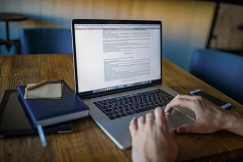 Business man using laptop computer for online banking while sitting in office Stock Photos