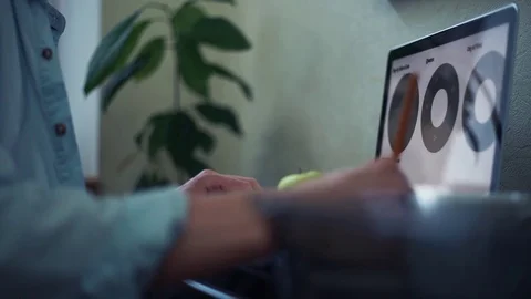 Business man using laptop at the office. White coffee cup at desk. Guy scrolling Stock Footage 82932618