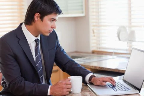 Business man using laptop while having coffee Stock Photos