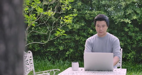Business man using the laptop for working online in the garden Video stock 130463809