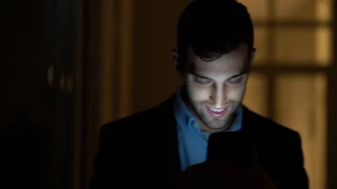 Business man using mobile alone in dark office Stock Footage 88560109