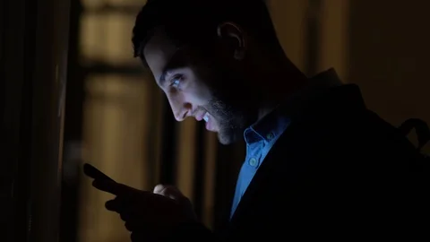Business man using mobile alone in dark office Stock Footage 88560438