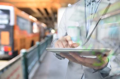 Business Man using Mobile Digital tablet in Bus Station Stock Photos