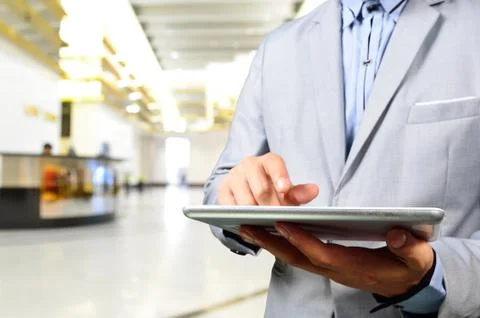 Business Man Using Mobile Digital Tablet in Modern Building. Stock Photos
