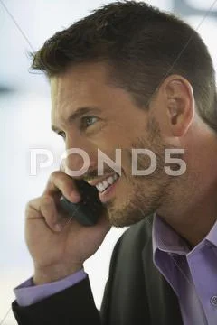 Business man using mobile phone, smiling, portrait Stock Photos