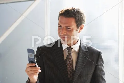 Business man, using mobile phone, close-up Stock Photos