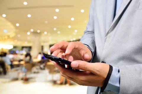 Business man using mobile smart phone in Restaurant Stock Photos