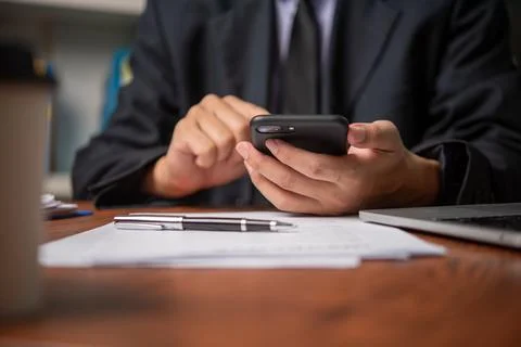 Business man using mobile smart phone management information financial docu.. Stock Photos