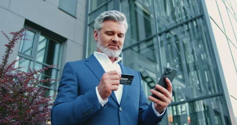 Business man using smartphone and credit card for online banking while sitting n Stock-Footage 331161696