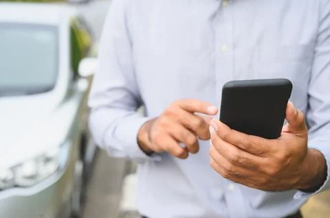 Business man using smartphone standing near car background. Man using smart.. Stock Photos
