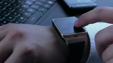 Business man using smartwatch app near pc keyboard and smartphone Stock Footage 66297011