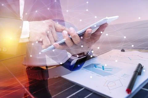 A business man using a tablet computer. Science solar energy, engineer workin Stock Photos