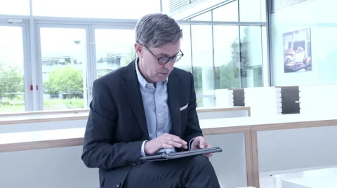Business man using tablet in office lobby Stock Footage 59384990
