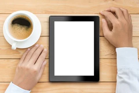 Business man using tablet white screen display with coffee drink on wood desk Stock Photos