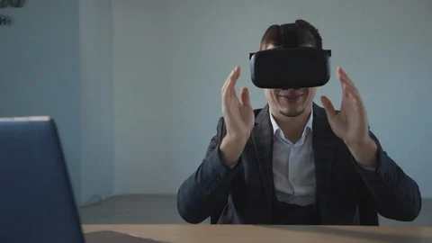 Business man in virtual reality glasses smiling and doing swiping moves Stock Footage 119462553