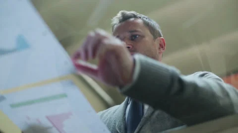 Business man working on documents in the office Видео 37128096