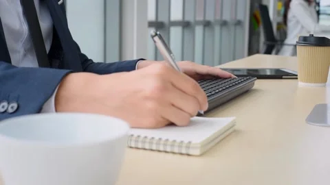 Business man working in front of computer typing on keyboard in modern office Stock Footage 161322696