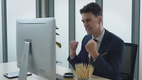 Business man working in front of computer acting success and happy. Stock Footage 161322831