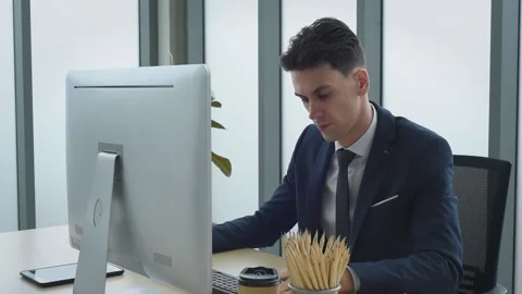 Business man working in front of computer typing on keyboard in modern office. Stock Footage 161322902