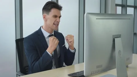 Business man working in front of computer acting success and happy. Stock Footage 161322937