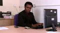 Business man working on his computer gets a call HD Footage