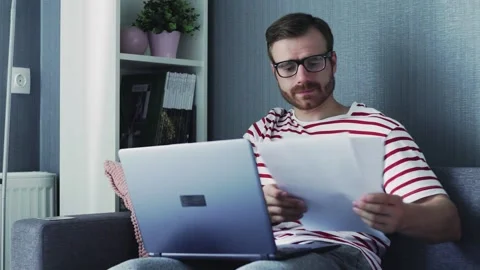 Business man working with laptop computer and documents at home Stock Footage 130359154