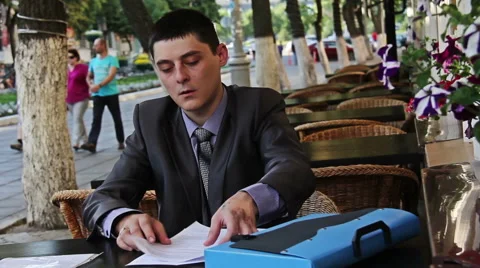 Business  man  works with documents in the cafe Stock Footage 40310166