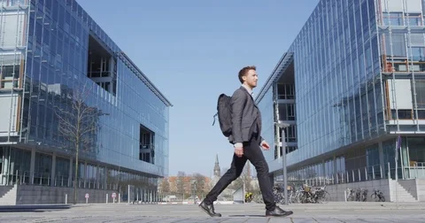 Business man - Young urban professional businessman walking to work Stock Footage