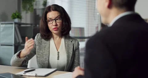 Business manager explaining contract terms to client during office meeting Stock Footage 332130595